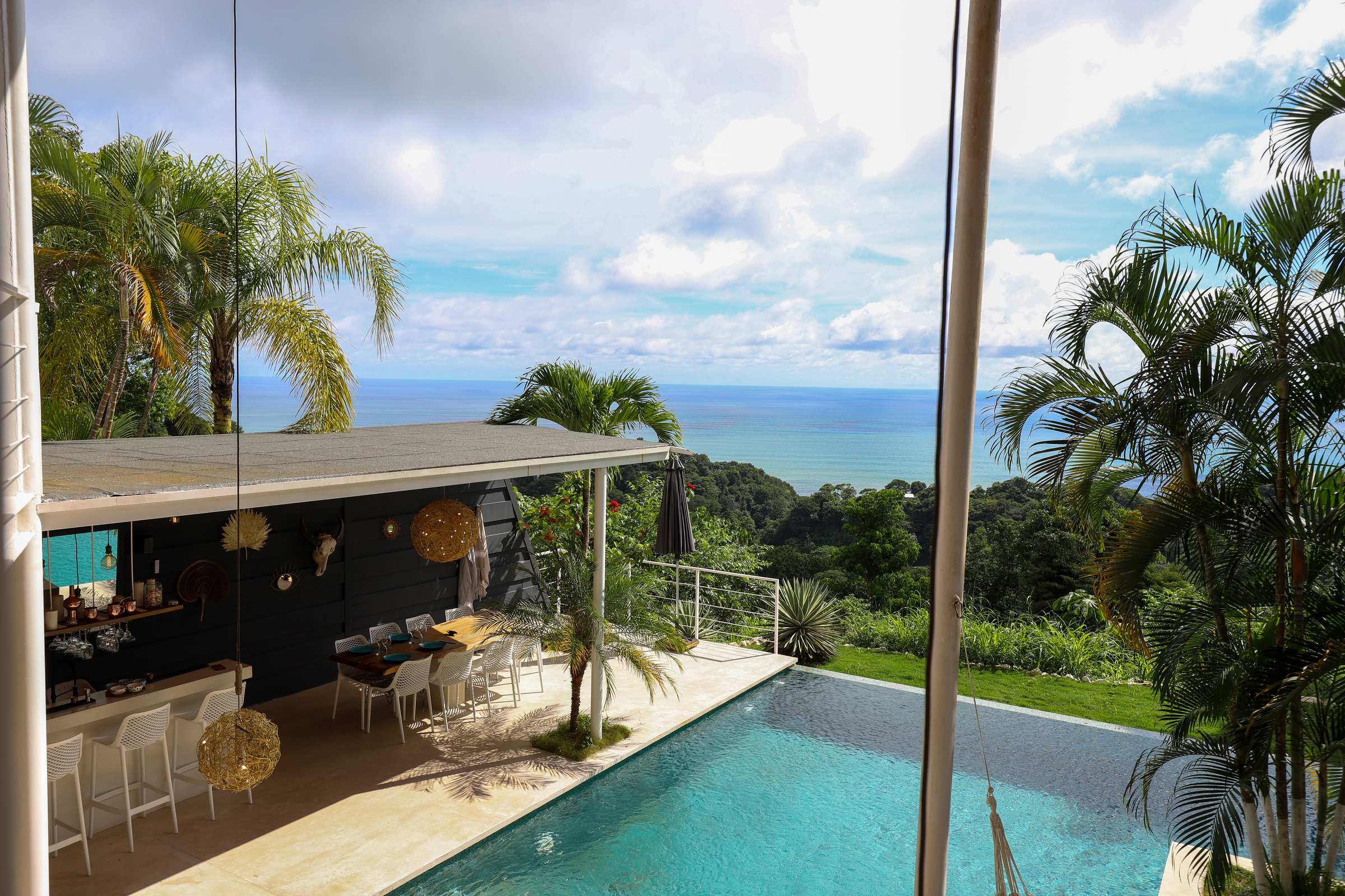 Casa Noa — pool and ocean view at midday.