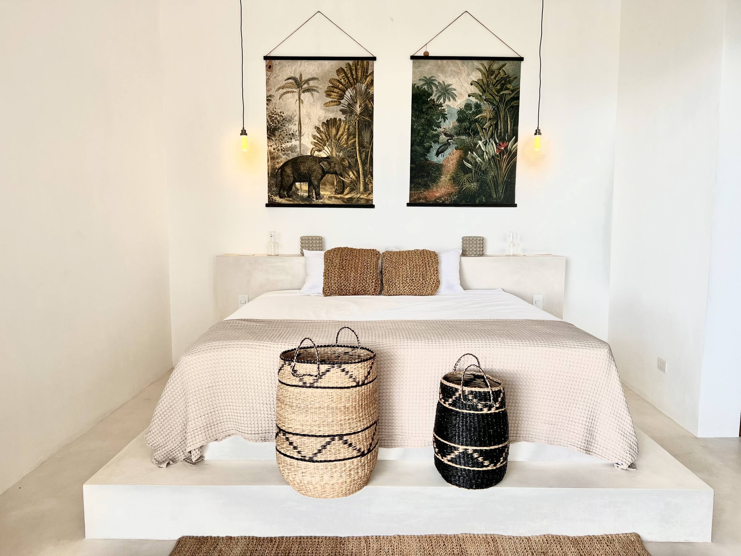Nouli — bedroom, white linen and jungle prints.